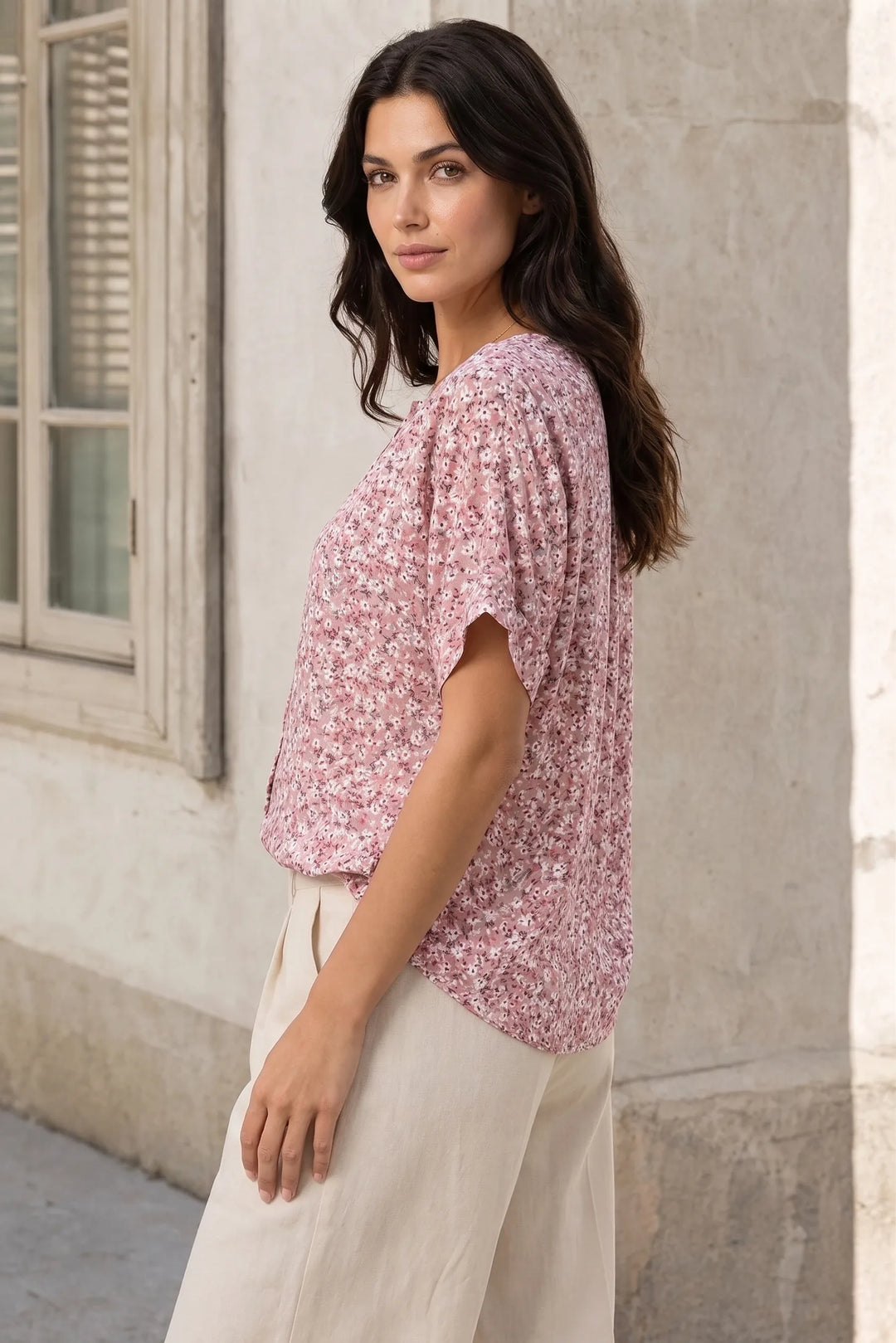 Ditsy floral button blouse on a model at a three-quarter turn