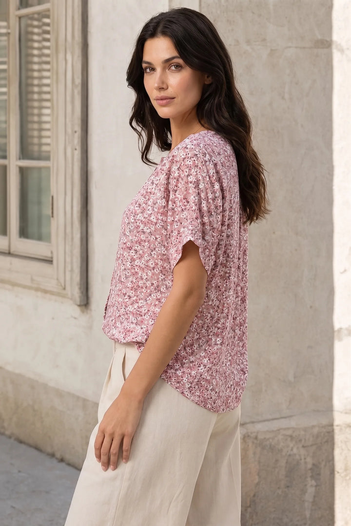 Ditsy floral button blouse on a model at a three-quarter turn