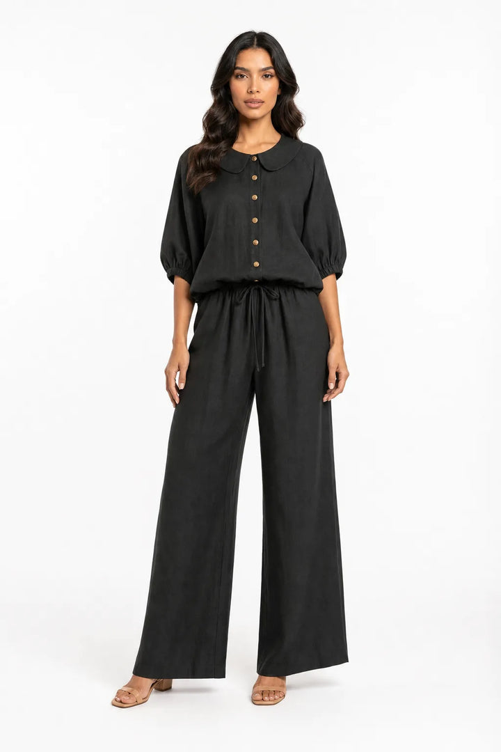 Black peter pan collar matching set on model in contrapposto stance