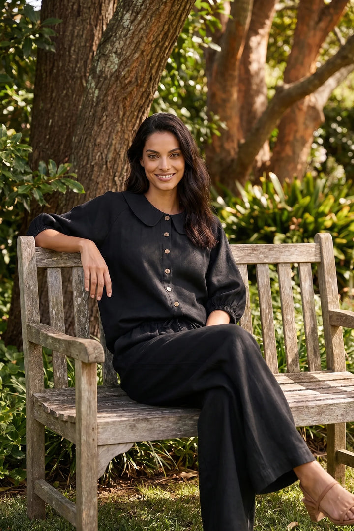 Model styled in black peter pan collar top and shorts set in casual lifestyle scene