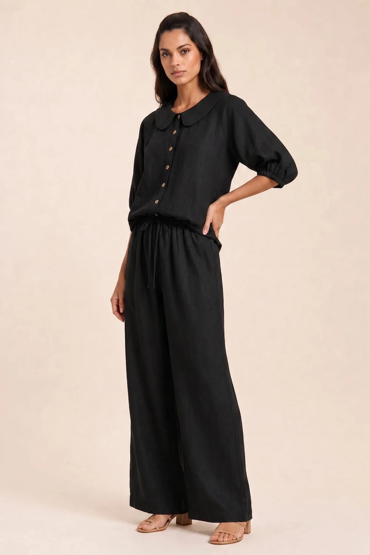 Black peter pan collar top and shorts set on model in three-quarter turn pose