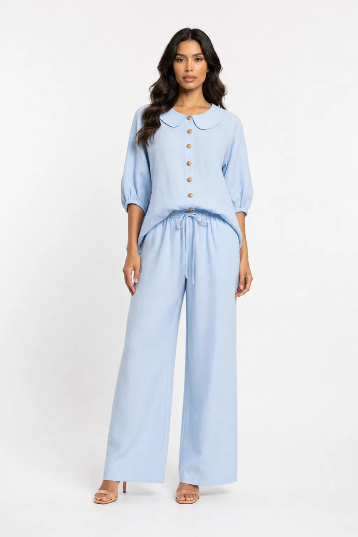 Blue peter pan collar matching set on model in contrapposto stance
