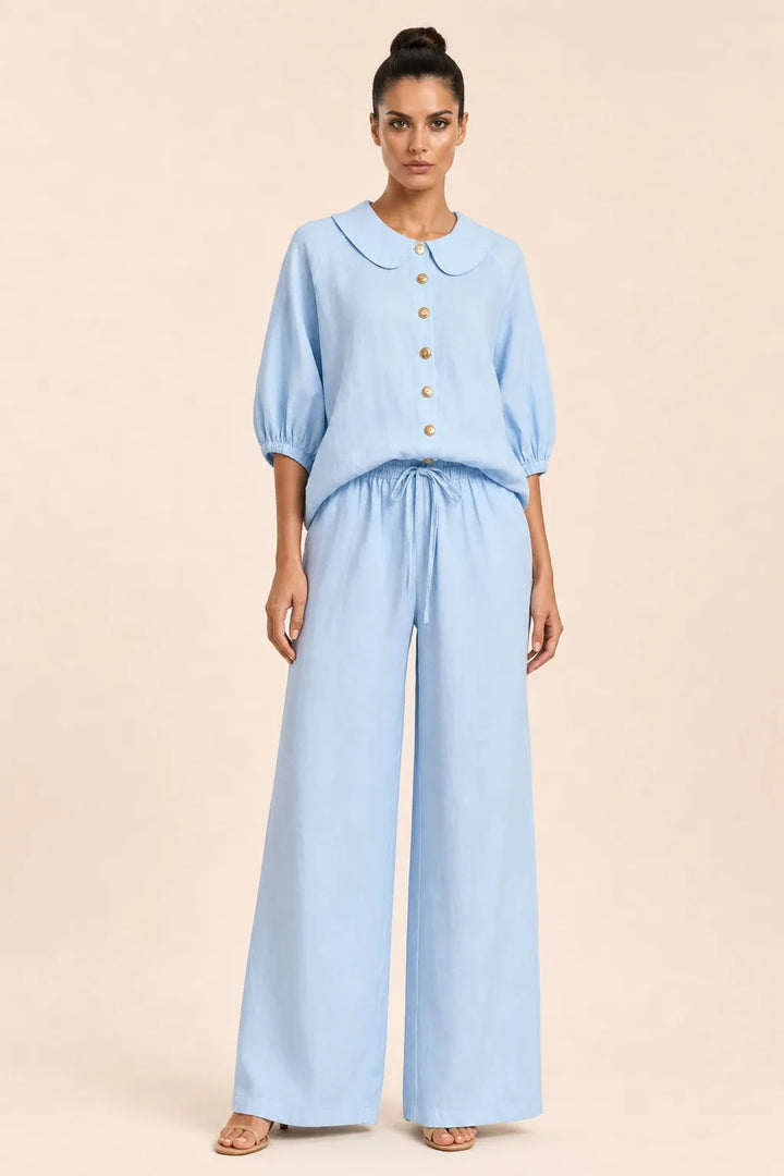 Blue peter pan collar top and matching shorts set on model in contrapposto stance