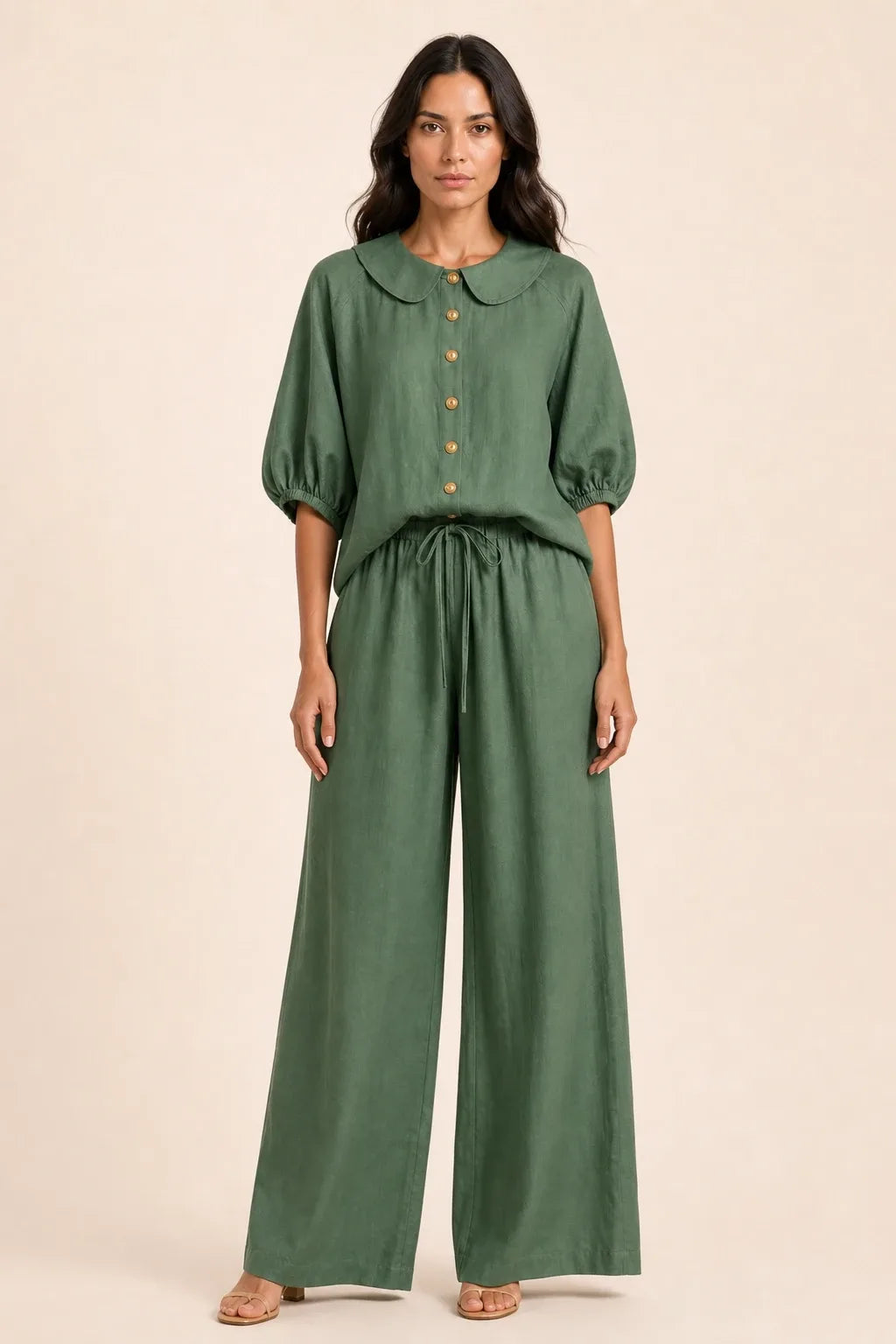 Green peter pan collar top and matching shorts set on model in contrapposto stance