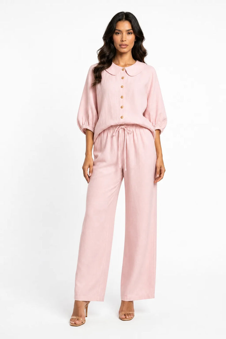 Pink peter pan collar matching set on model in contrapposto stance