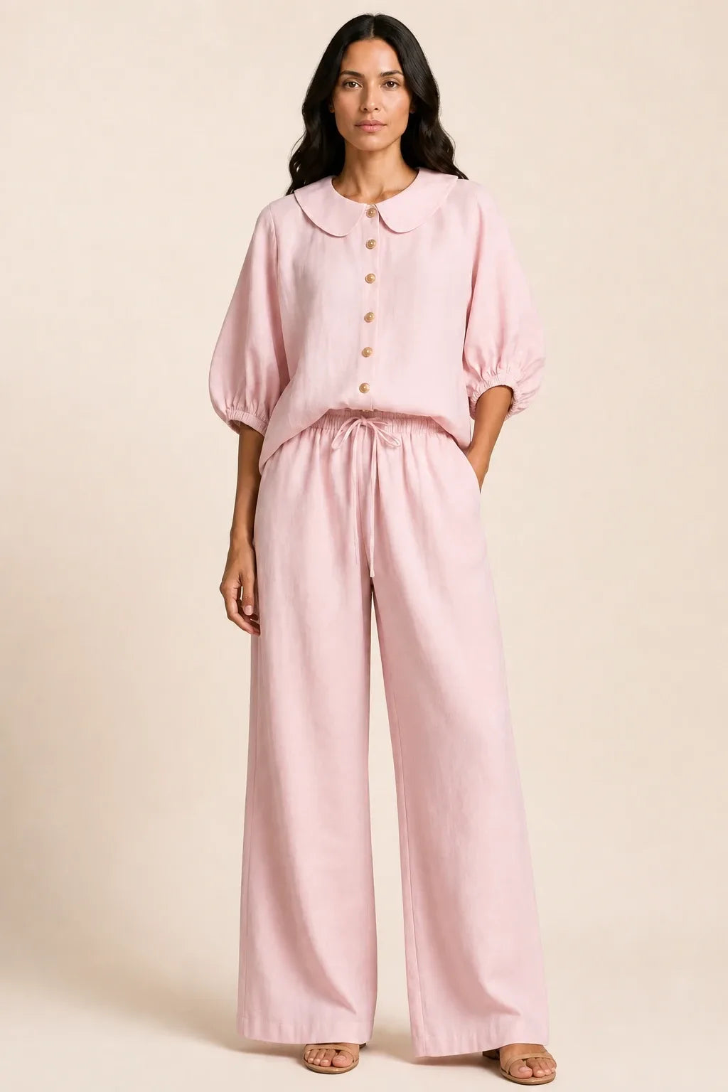 Pink peter pan collar top and matching shorts set on model in contrapposto stance