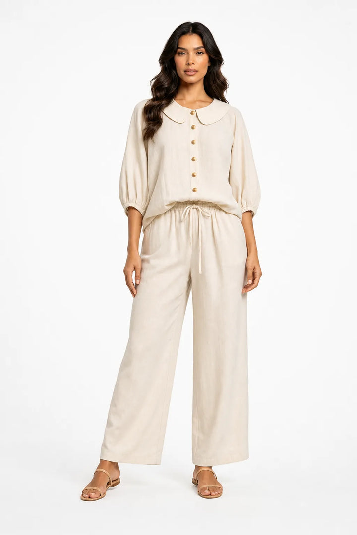 White peter pan collar matching set on model in contrapposto stance