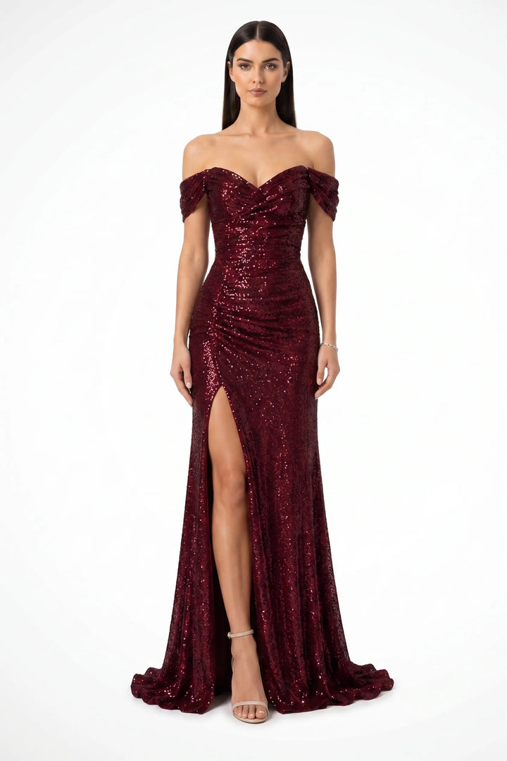 Wine red sequin ruched gown on a model in a contrapposto stance