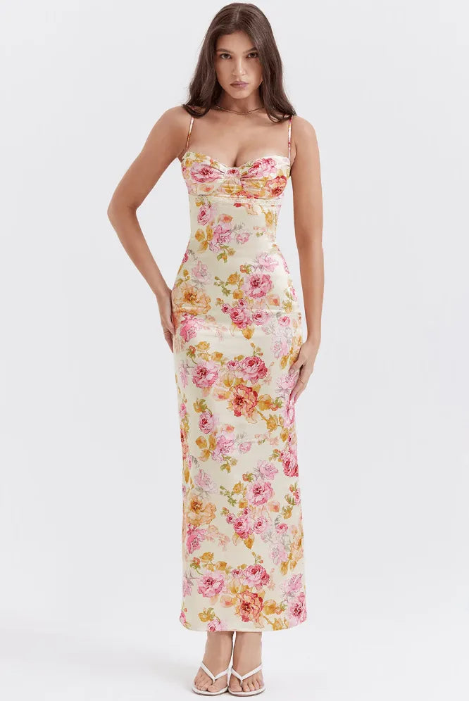 Model facing forward in a pink floral satin maxi dress with a flowing silhouette