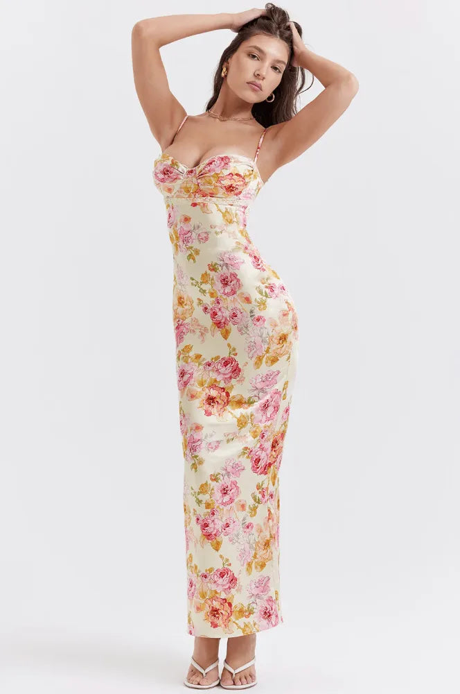 Model in side profile wearing a pink floral satin maxi dress