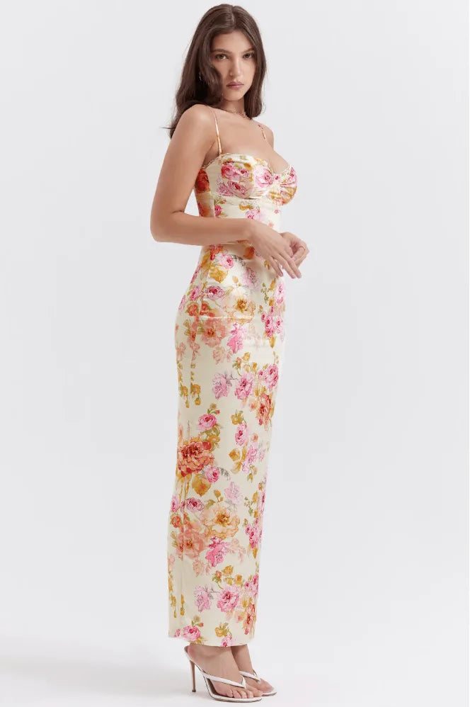 Model posing in a pink floral satin maxi dress