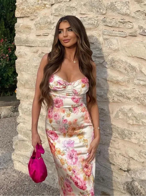 Model posing in a pink floral satin maxi dress showing full length