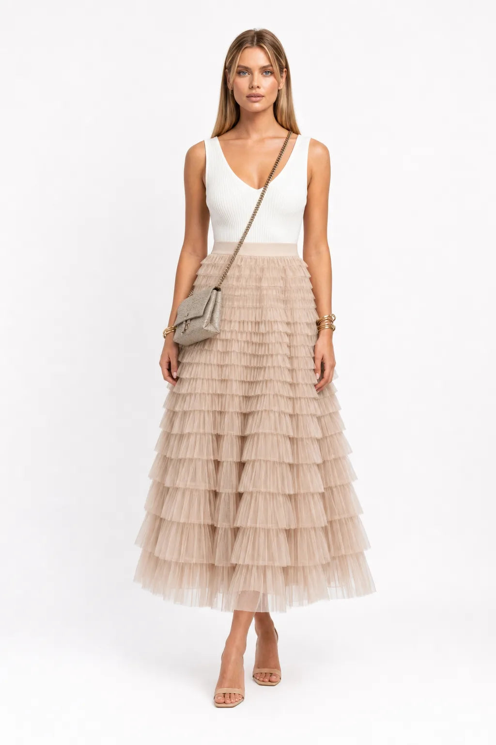 Beige tiered tulle maxi skirt on a model in a contrapposto stance