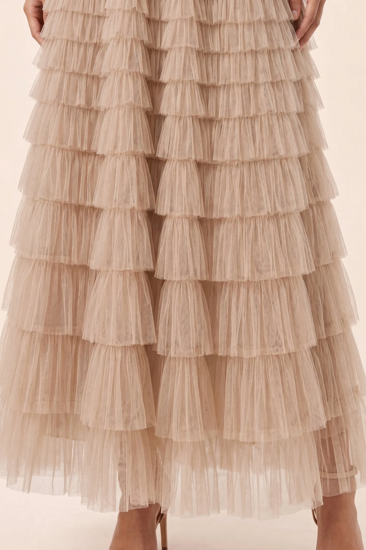 Close-up detail of a beige tiered tulle maxi skirt