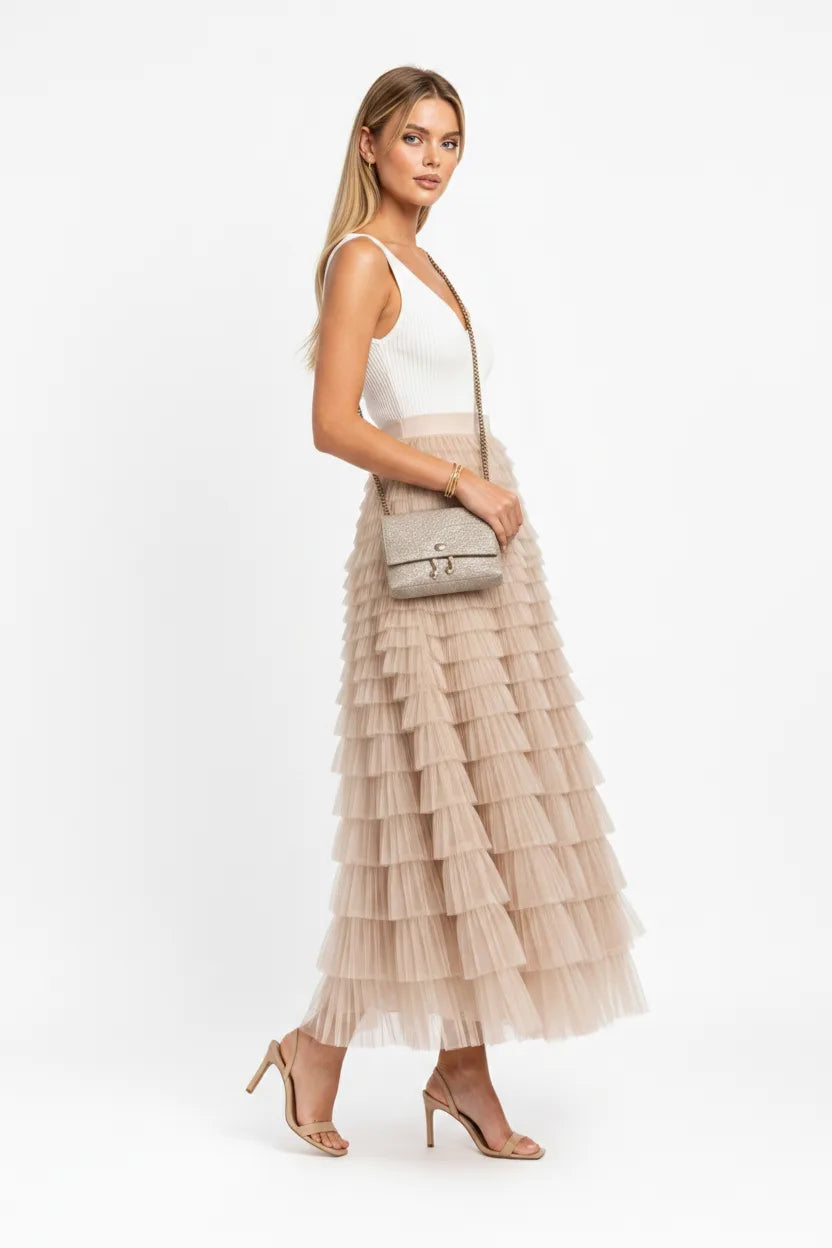 Beige tiered tulle maxi skirt on a model in a three-quarter turn