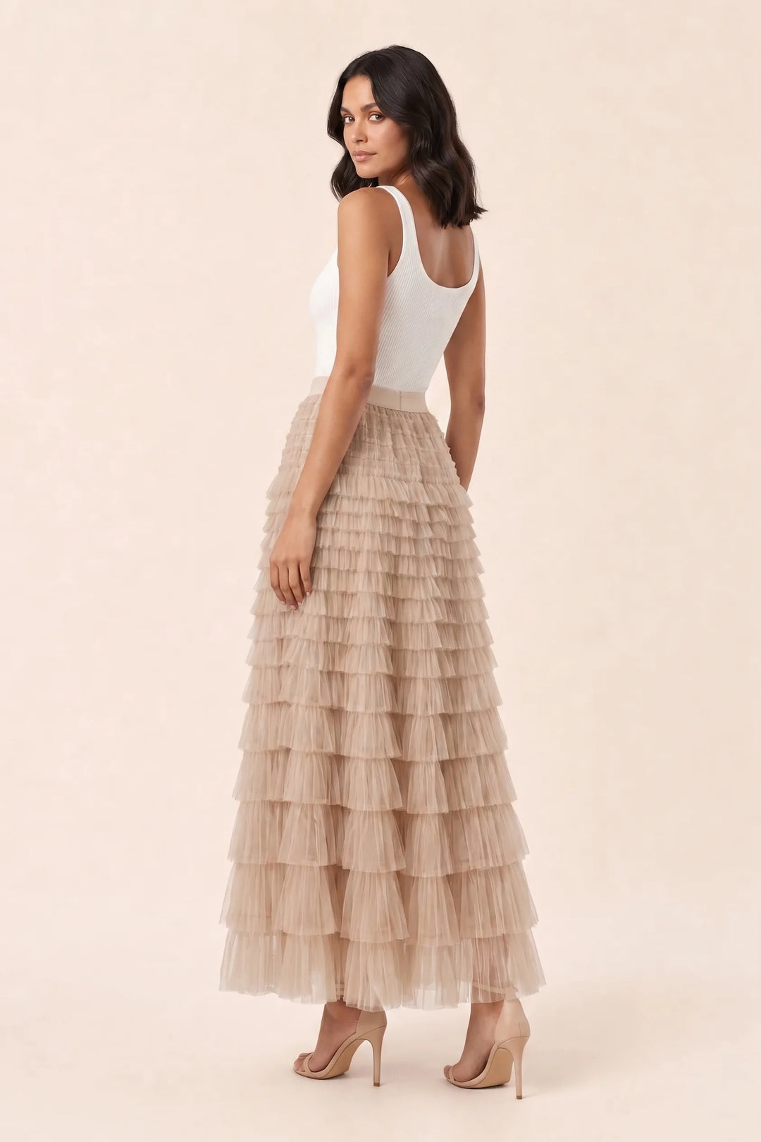 Beige tiered tulle maxi skirt on a model in a three-quarter turn