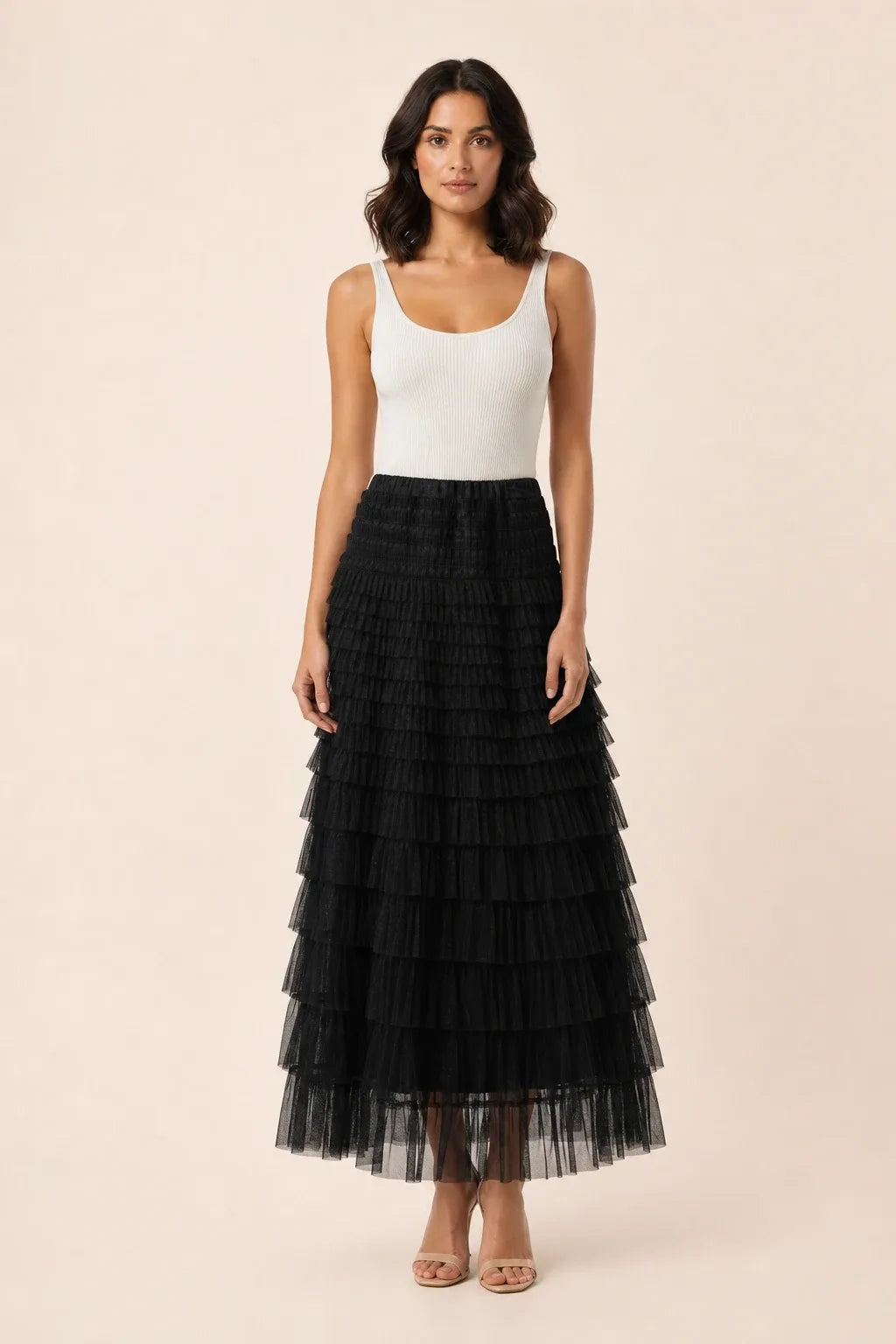 Black tiered tulle maxi skirt on a model in a contrapposto stance