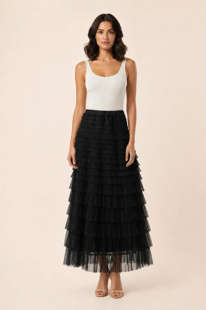 Black tiered tulle maxi skirt on a model in a contrapposto stance