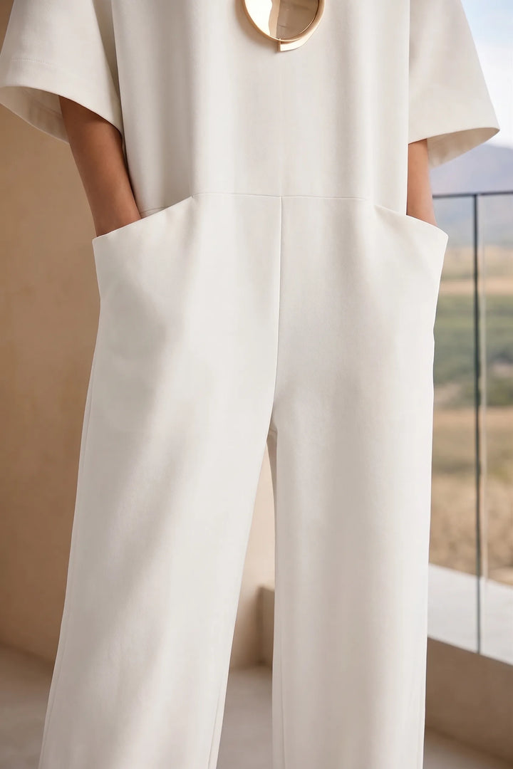 Close-up detail of white wide-leg jumpsuit fabric and construction