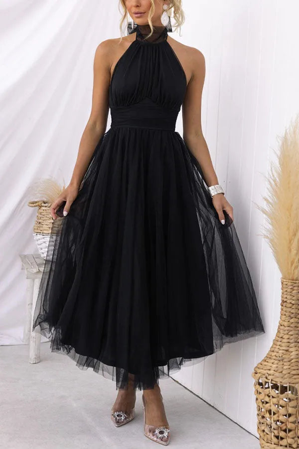 Close-up detail of a black tulle halter midi dress showing fabric and bodice construction