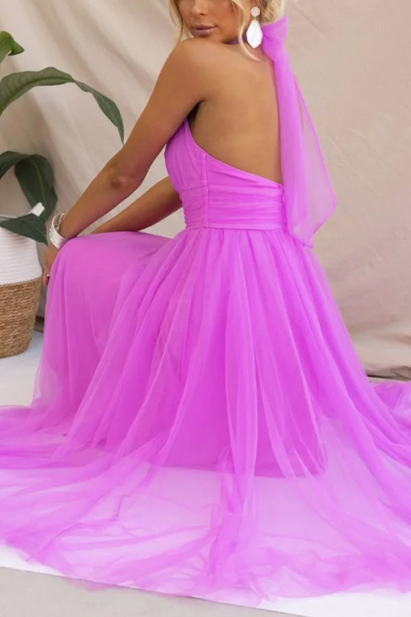 Model in a dark pink tulle halter midi dress with a voluminous layered tulle skirt