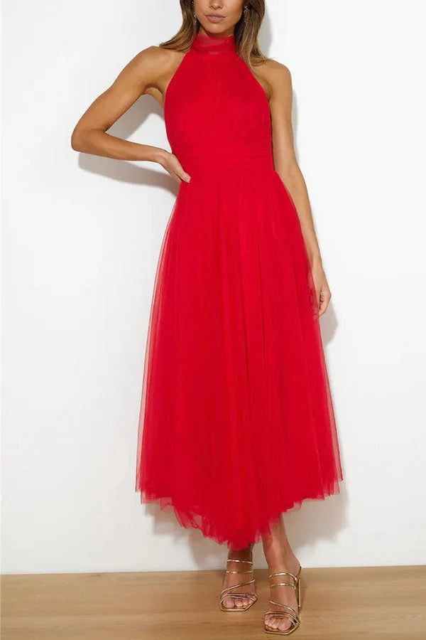 Model wearing a red tulle halter midi dress with a full layered skirt