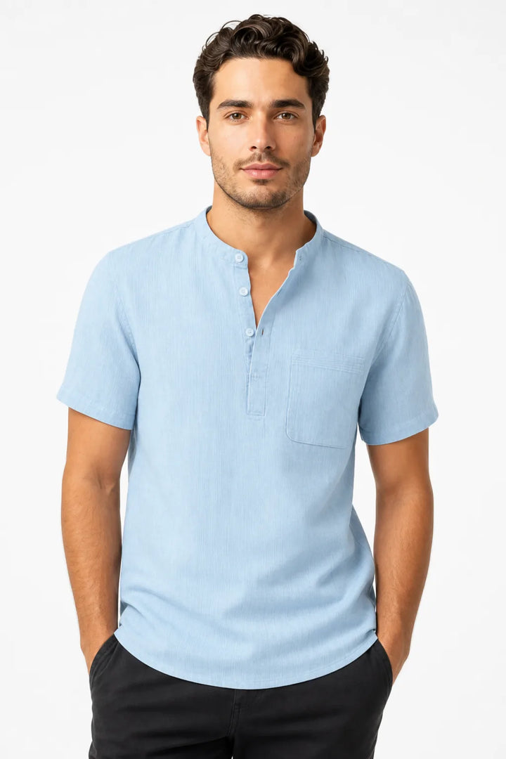 Light blue linen henley popover shirt on male model in contrapposto stance
