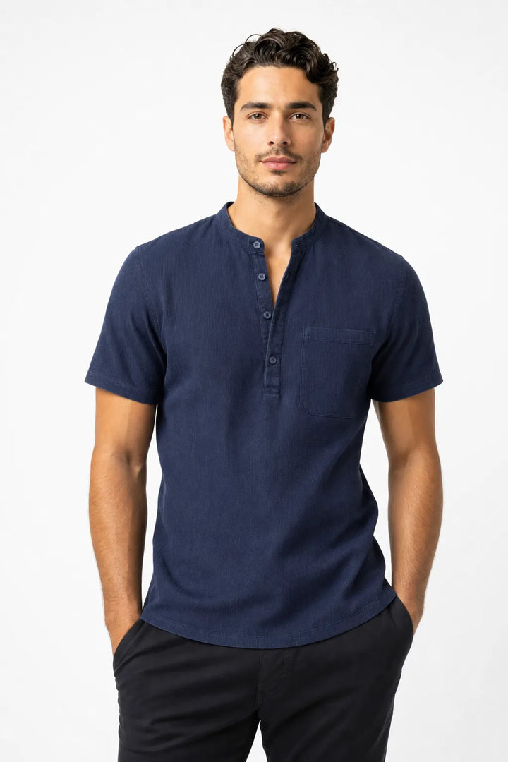 Navy blue linen henley popover shirt on male model in contrapposto stance