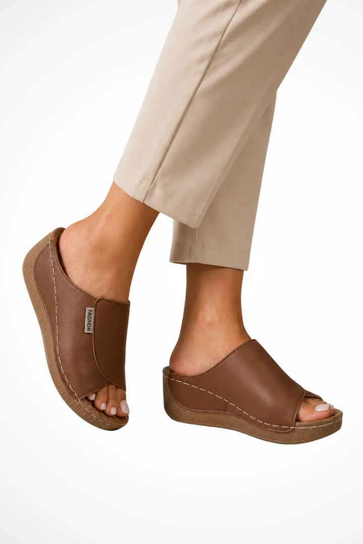 Brown wedge slip-on mule shown from the front