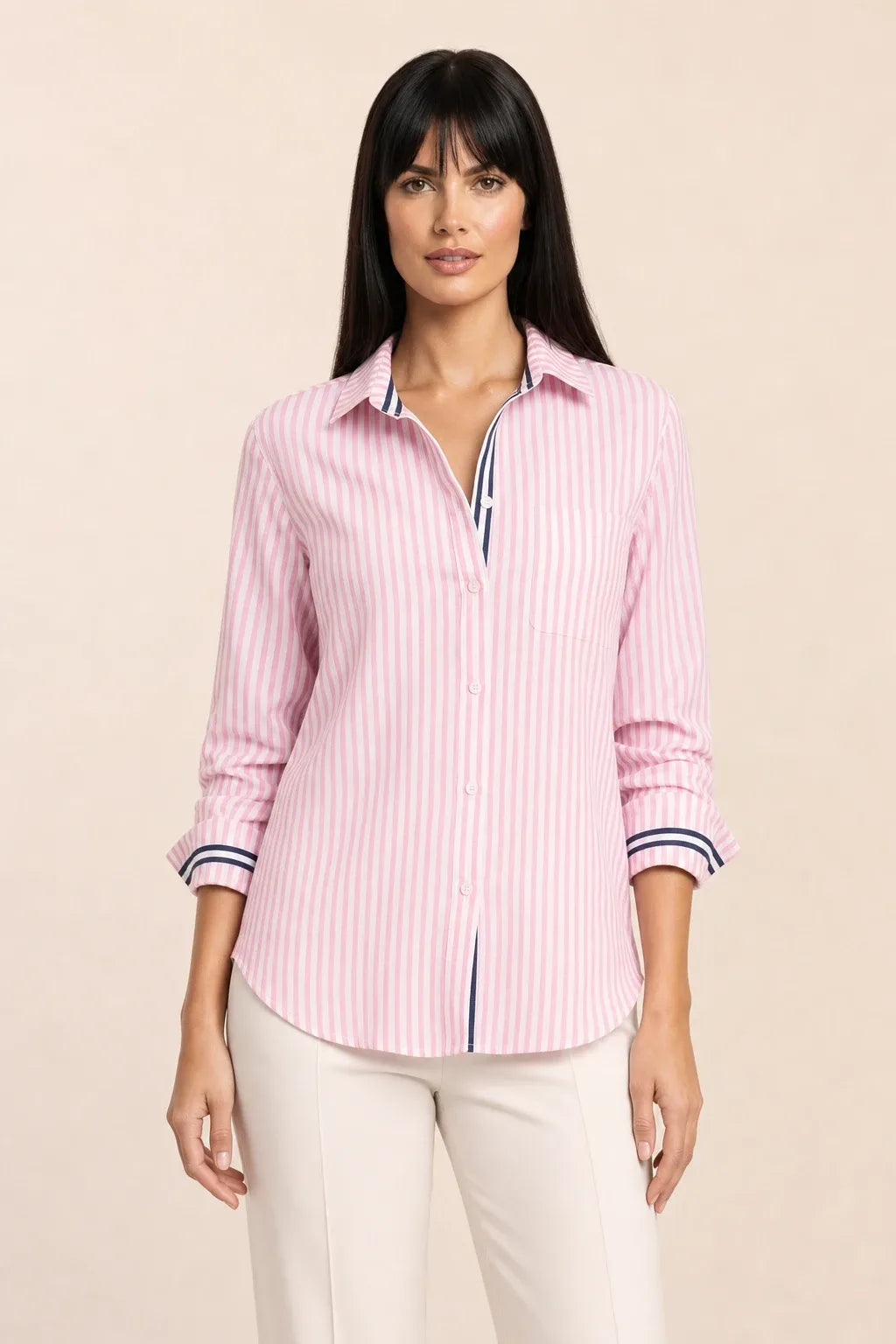 Oversized baby pink striped shirt on model in relaxed contrapposto stance