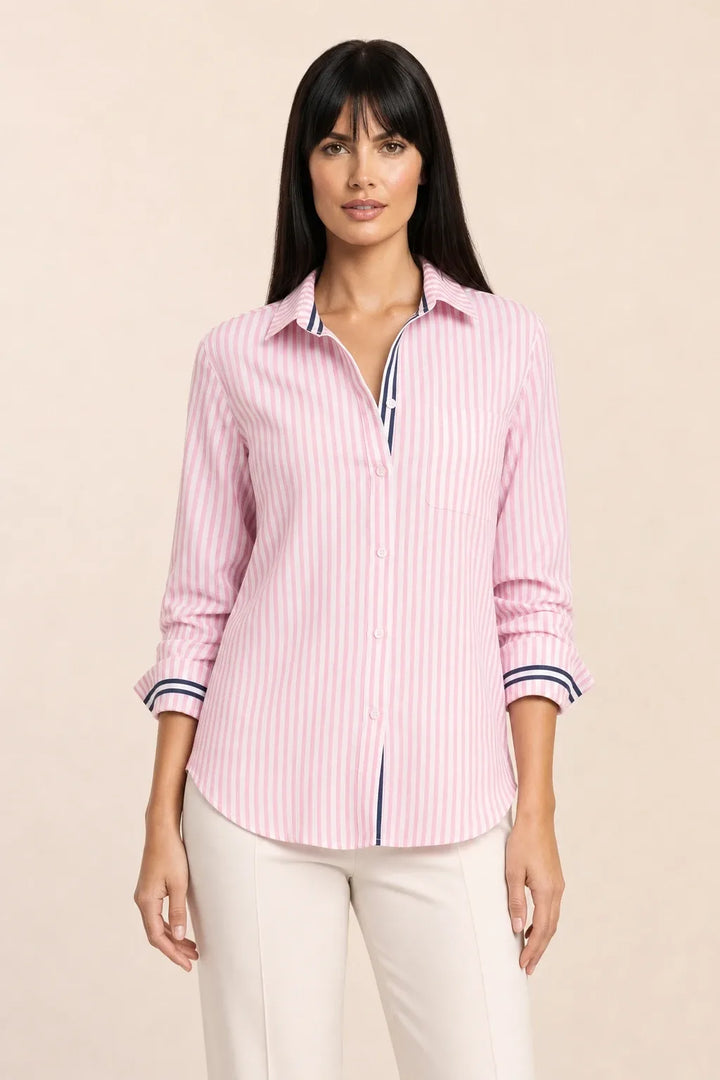 Oversized baby pink striped shirt on model in relaxed contrapposto stance
