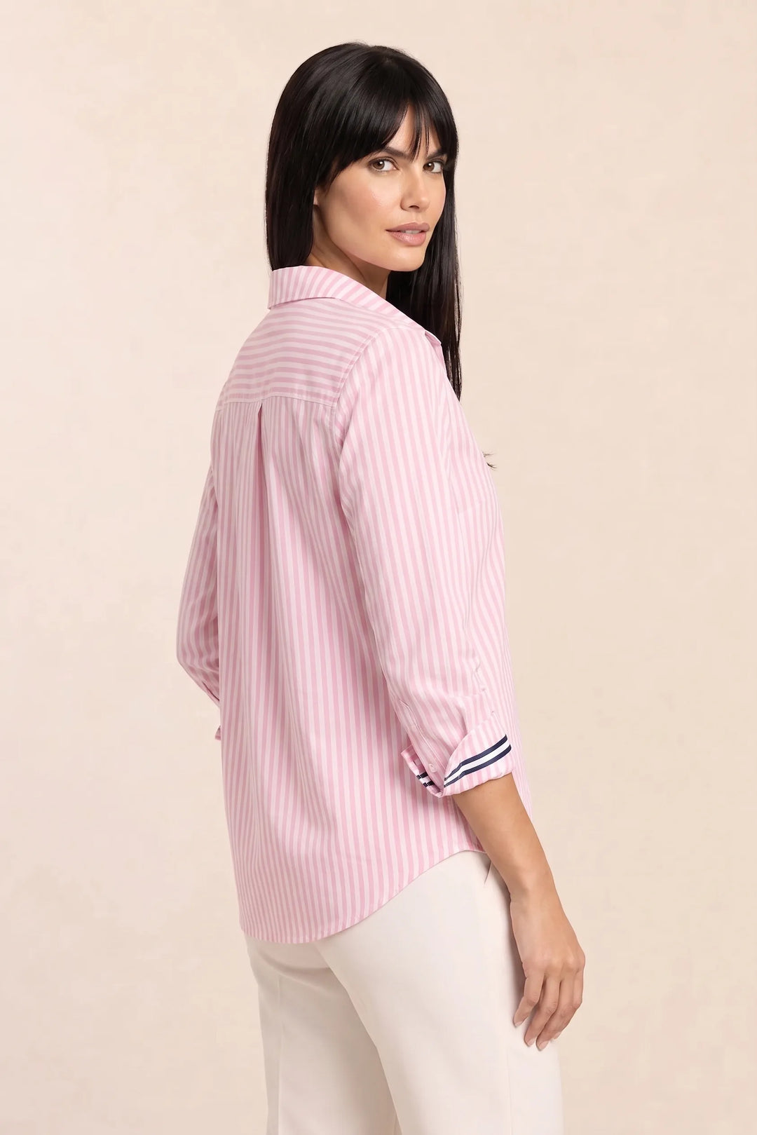 Oversized baby pink striped shirt on model in three-quarter turn pose