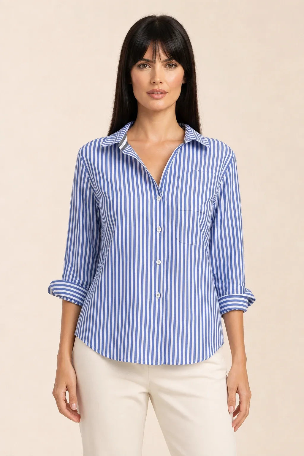Oversized blue striped shirt on model in relaxed contrapposto stance