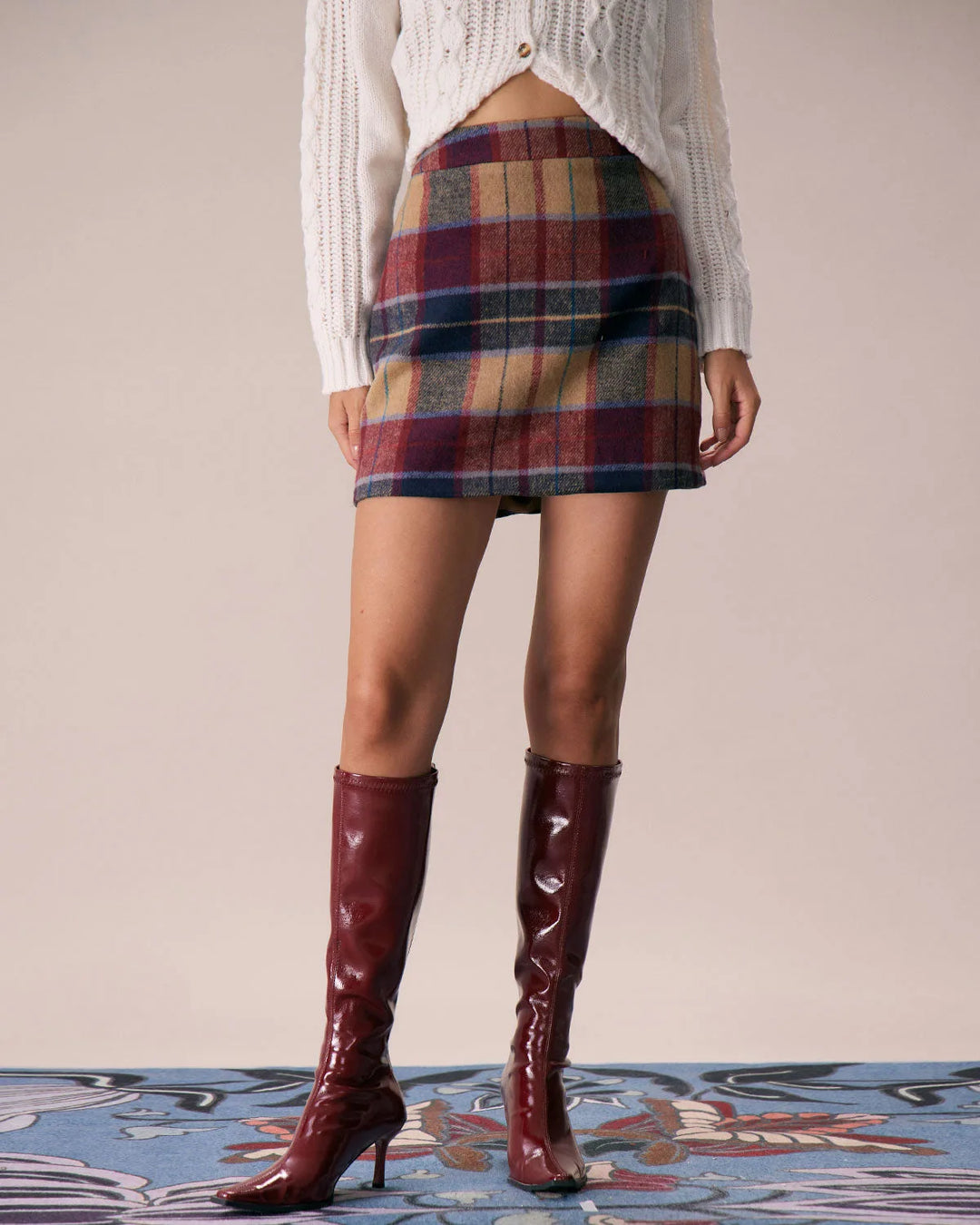 Close-up detail of red plaid mini skirt fabric and waistband