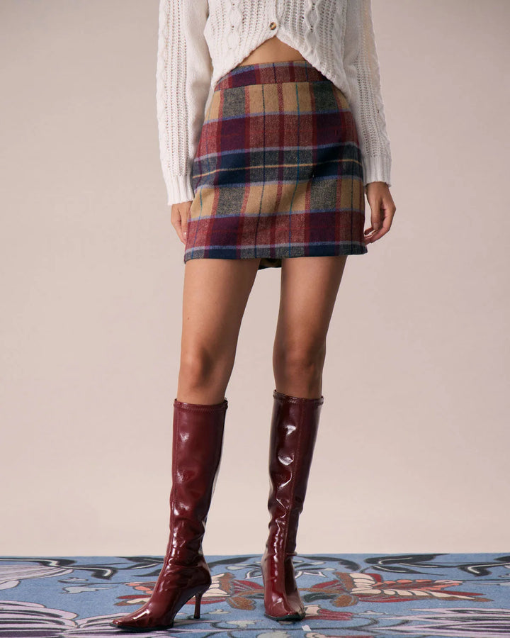 Close-up detail of red plaid mini skirt fabric and waistband