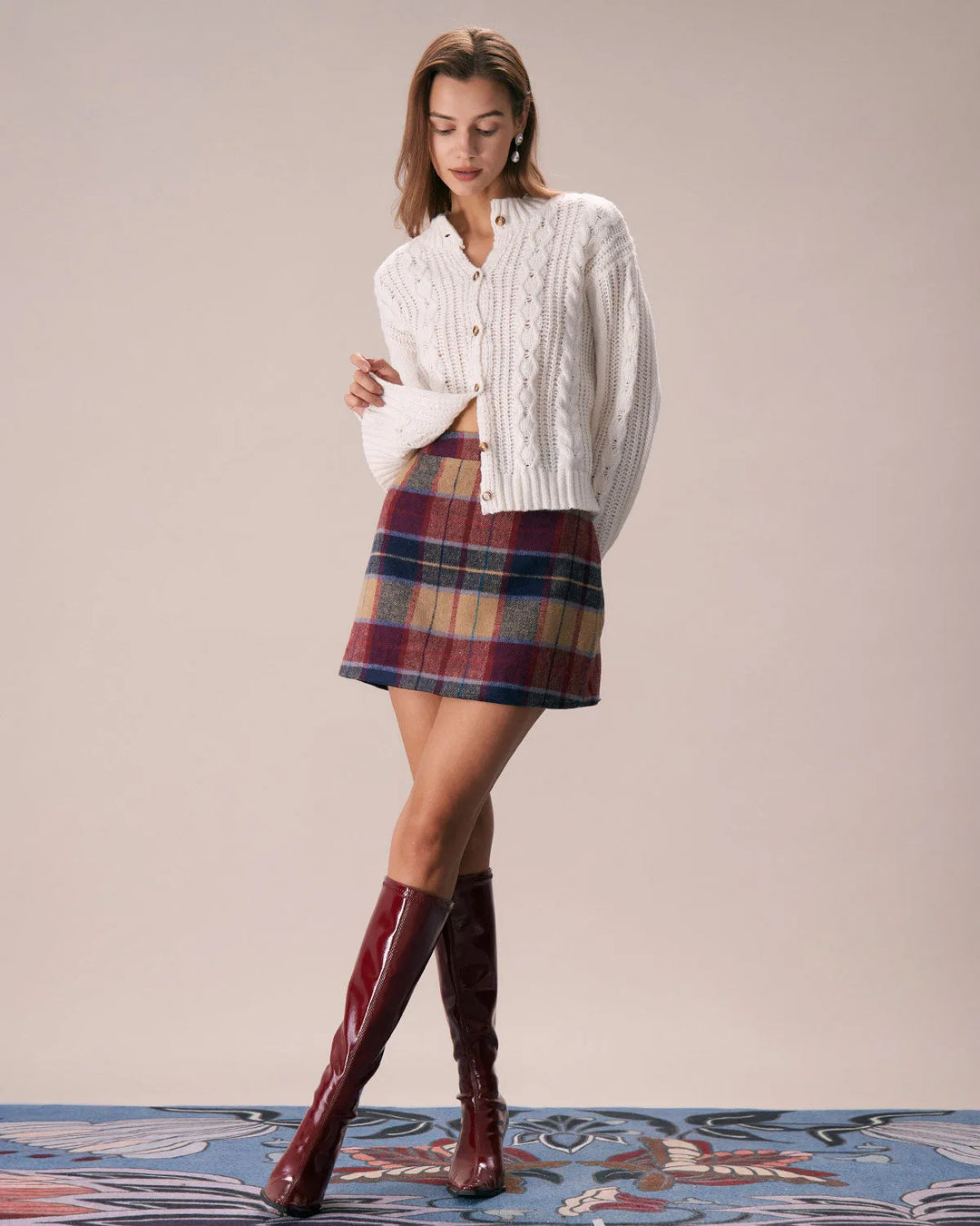 Model wearing a red plaid mini skirt in an alternate stance