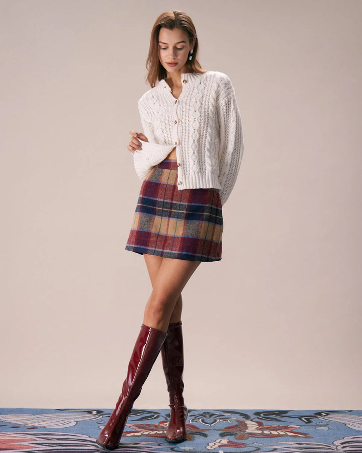 Model wearing a red plaid mini skirt in an alternate stance