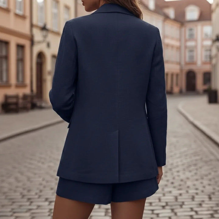 Model at three-quarter turn wearing a navy oversized double-breasted blazer