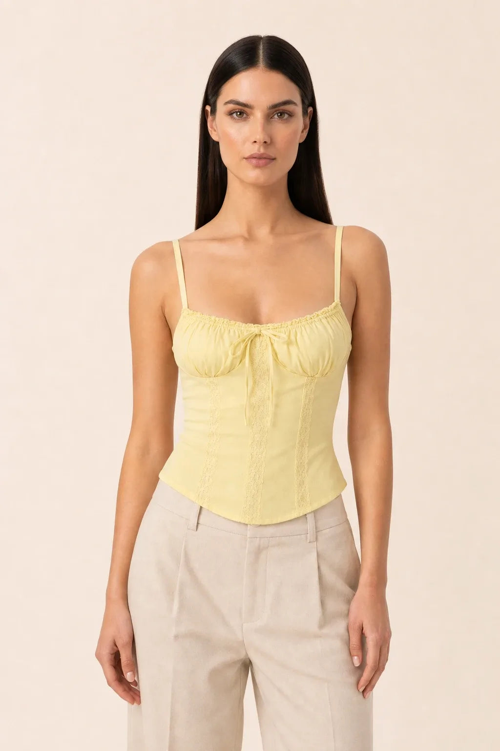 Yellow lace trim corset cami on a model in a contrapposto stance