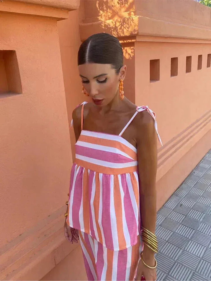 Woman styled in a blue striped peplum coord set, full-length view