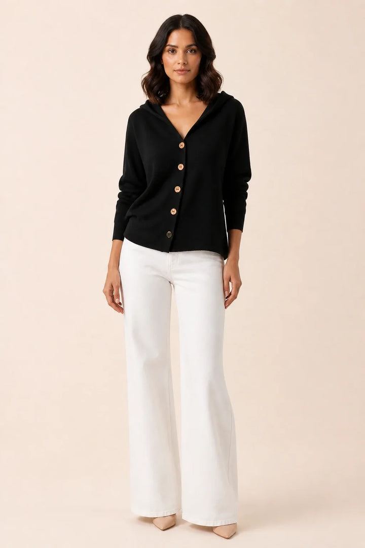 Black hooded button cardigan on a model in a contrapposto stance