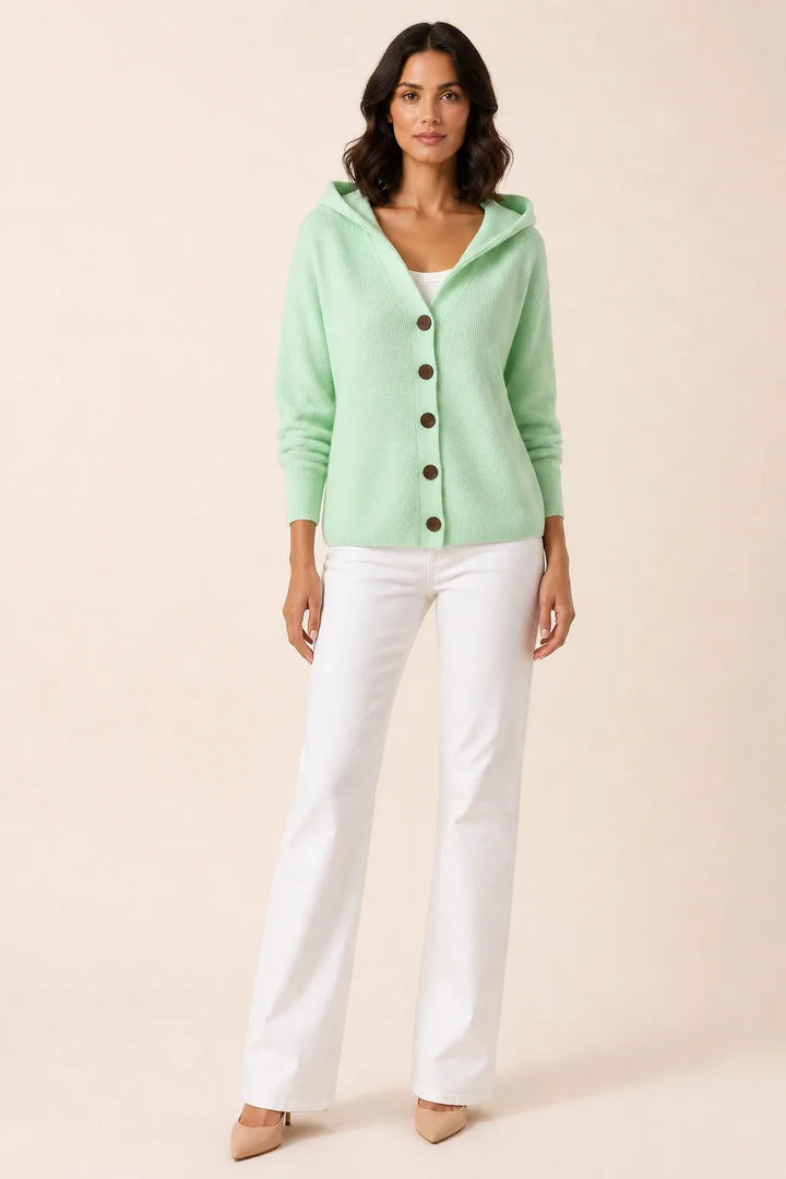 Green hooded button cardigan on a model in a contrapposto stance