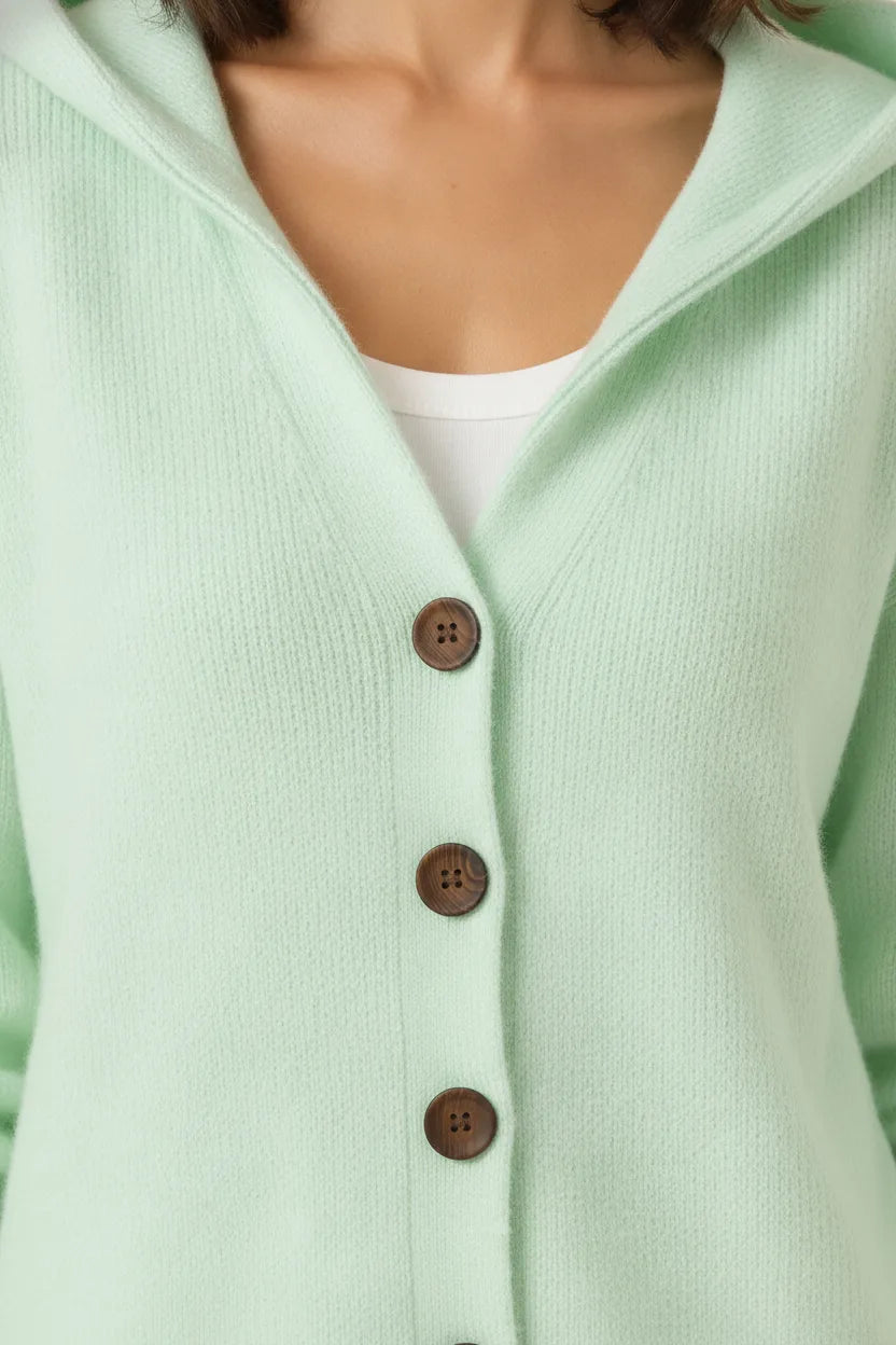 Close-up detail of a green hooded button cardigan