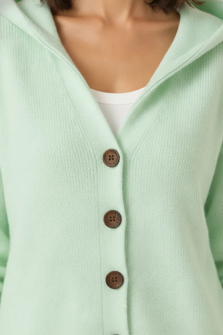 Close-up detail of a green hooded button cardigan