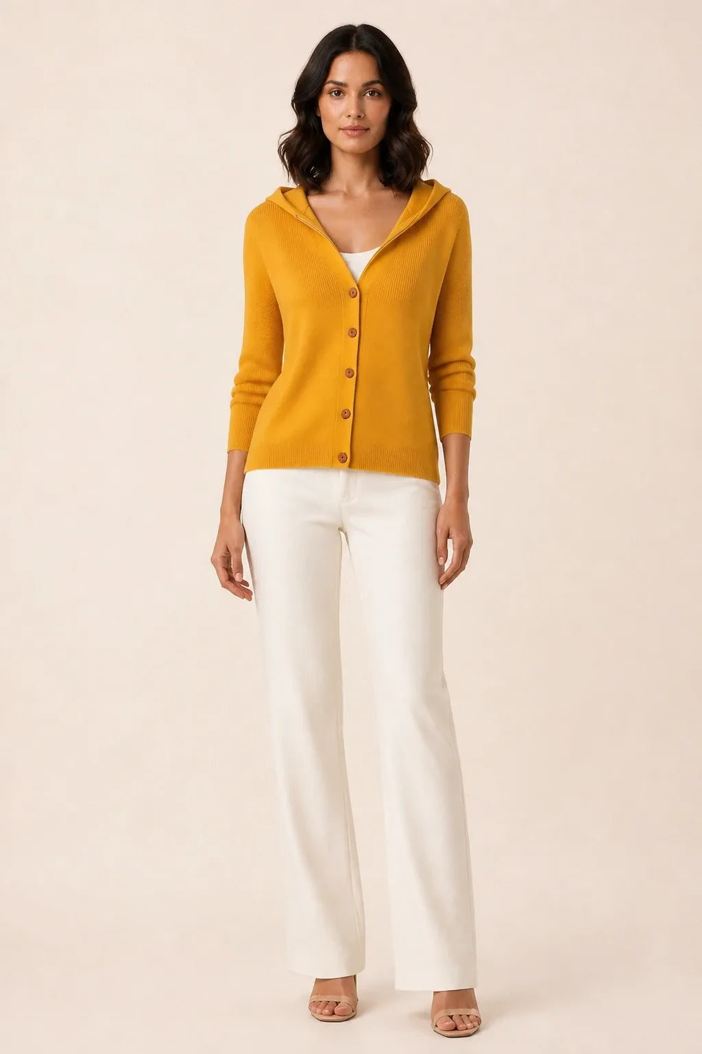 Orange hooded button cardigan on a model in a contrapposto stance