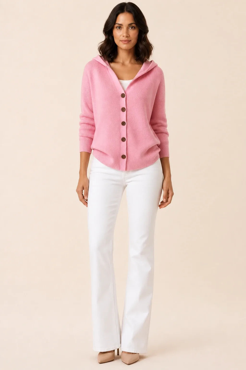 Pink hooded button cardigan on a model in a contrapposto stance