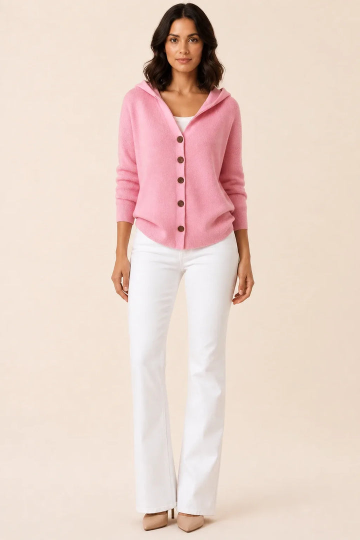 Pink hooded button cardigan on a model in a contrapposto stance