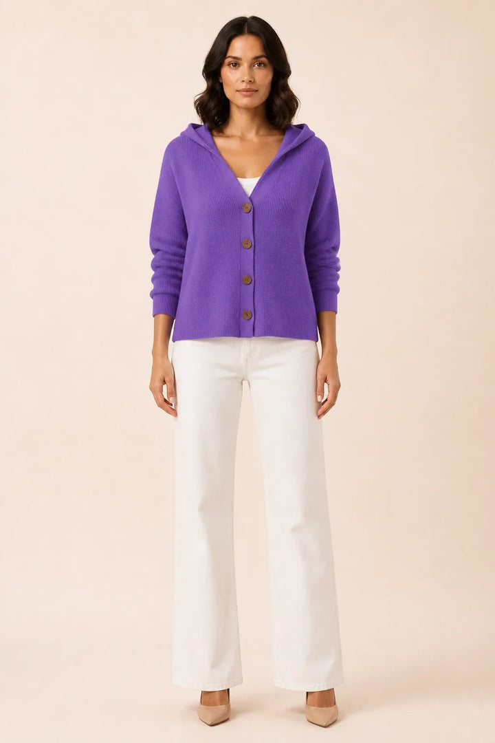 Purple hooded button cardigan on a model in a contrapposto stance