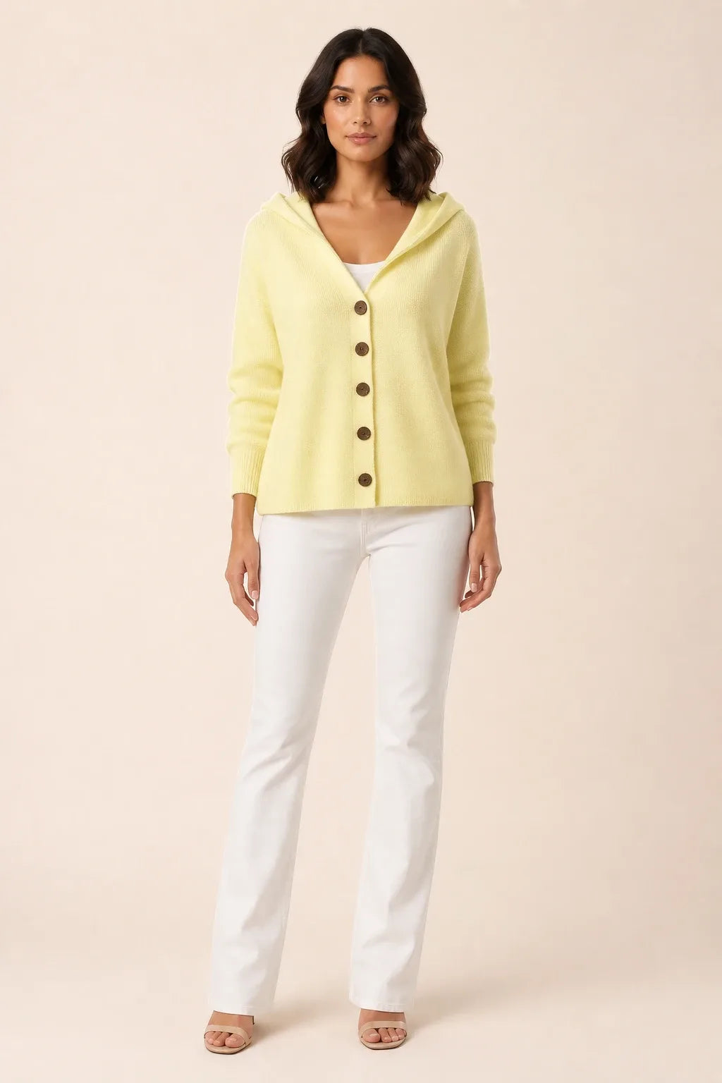 Yellow hooded button cardigan on a model in a contrapposto stance