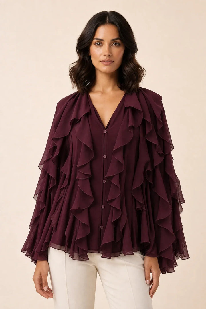 Brown cascading ruffle blouse on a model in a contrapposto stance